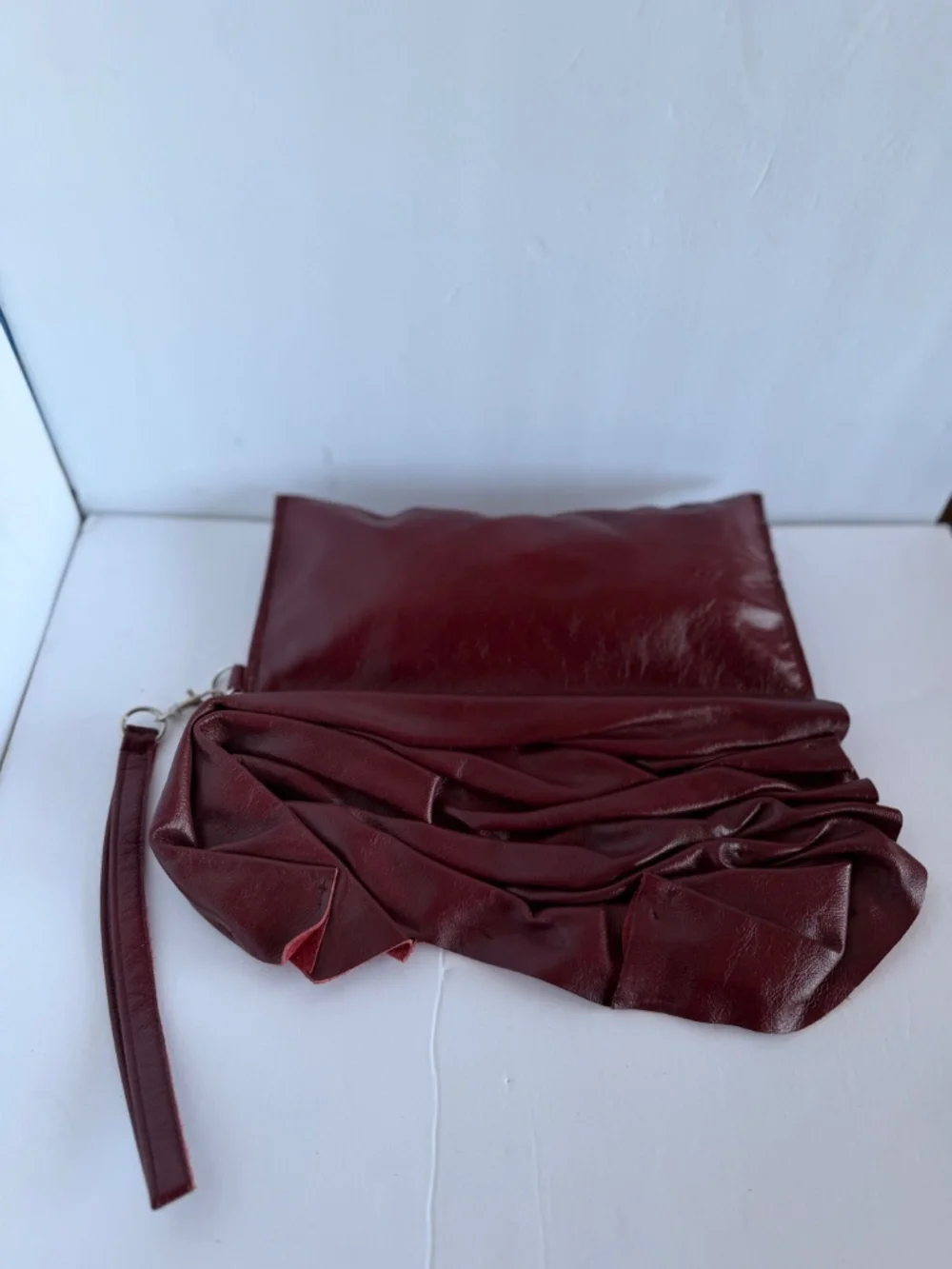 Burgundy Pleated Leather Handbag Featuring a Soft Ruched Design